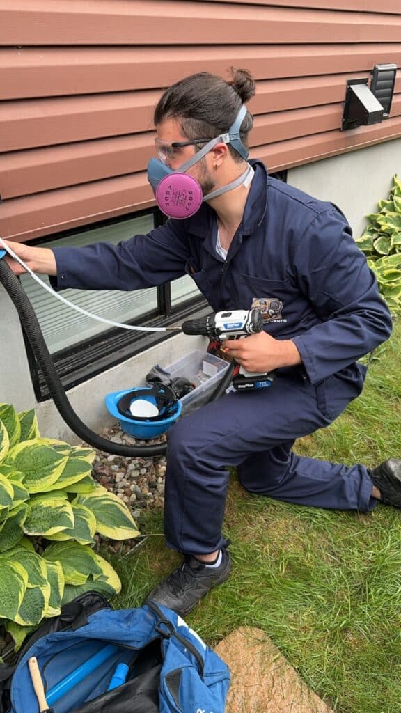 Technician Cleaning Dryer Vent in Laval