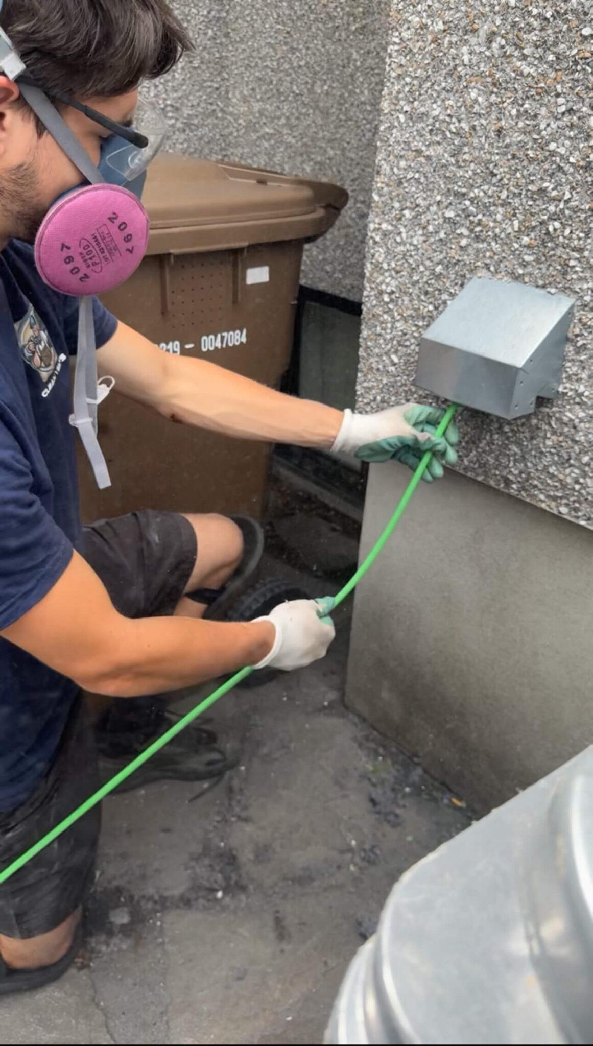 Technician Cleaning Dryer Vent in Laval
