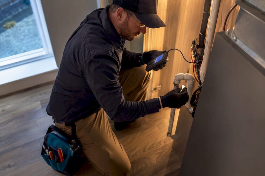 Technician performing HVAC system diagnostics